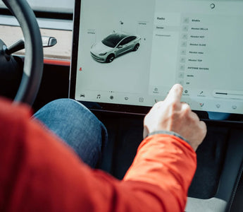 Person using the touchscreen inside a Tesla